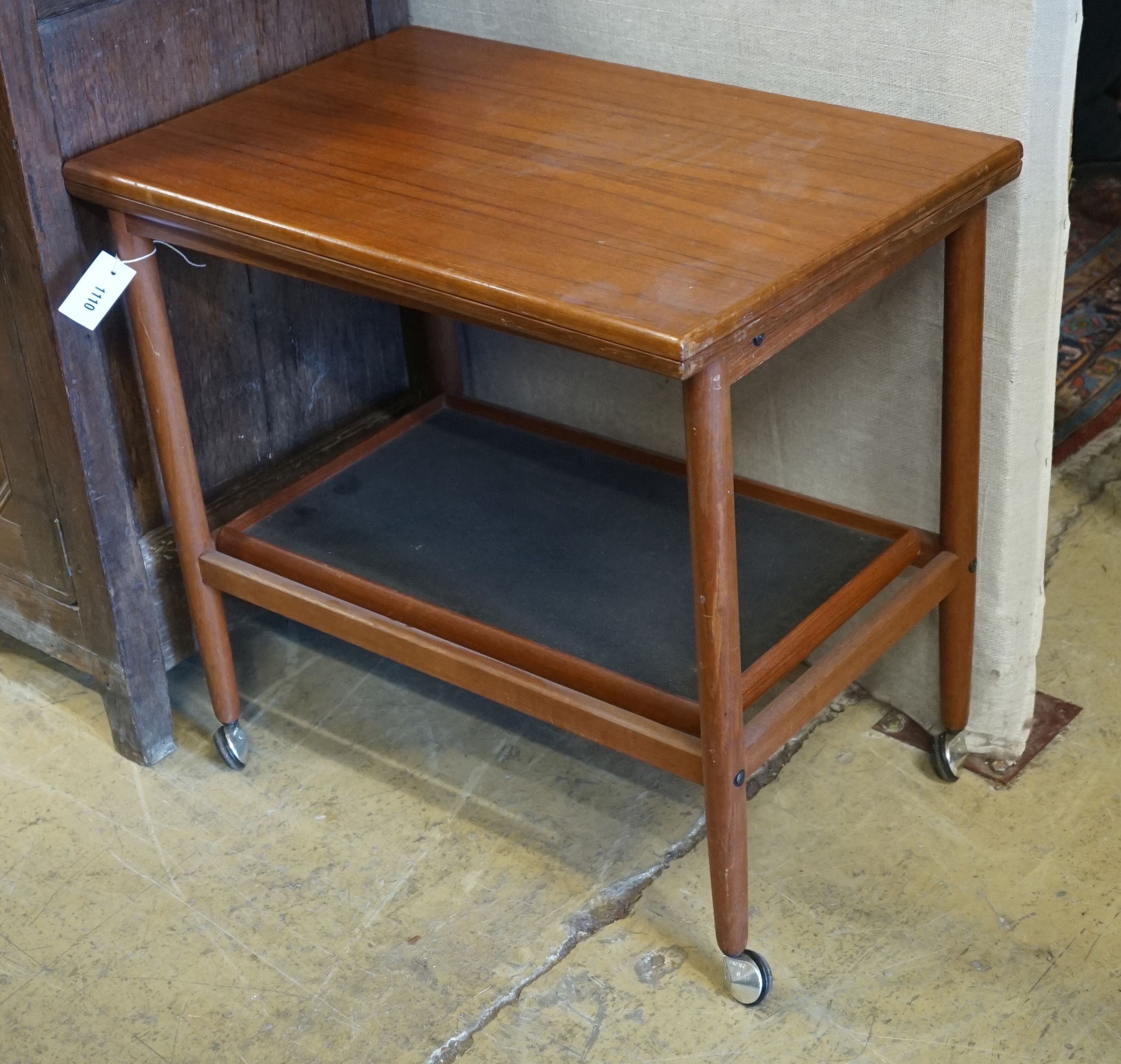 A Danish teak two tier tea trolley with folding top, width 70cm, depth 44cm, height 65cm